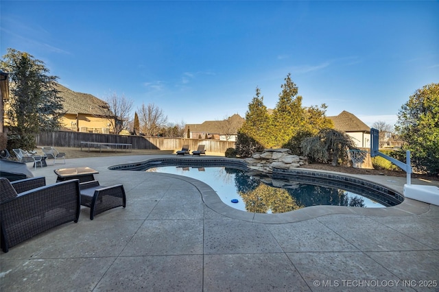 view of swimming pool with a trampoline and a patio