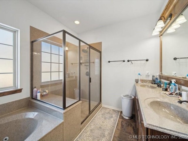 bathroom featuring vanity and separate shower and tub