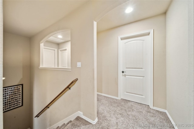 corridor with light colored carpet