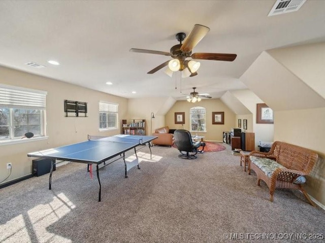 rec room with vaulted ceiling and light colored carpet