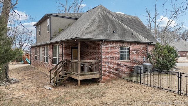 back of property featuring a playground