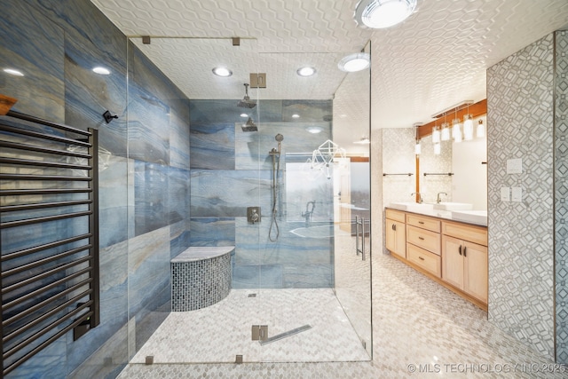 bathroom with vanity, a textured ceiling, and a shower with shower door