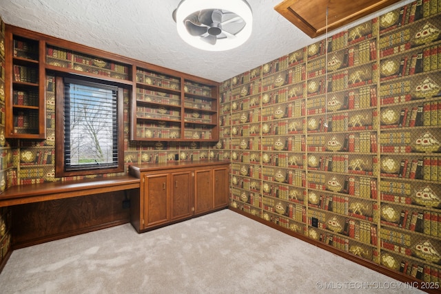 6642 E 60th Pl, Tulsa, OK 74145 - unfurnished office with attic access, built in desk, carpet floors, a textured ceiling, and wallpapered walls