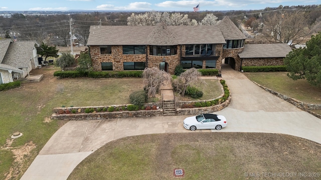 6642 E 60th Pl, Tulsa, OK 74145 - view of front facade with brick siding, a front lawn, and a balcony