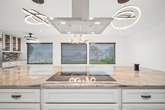 6642 E 60th Pl, Tulsa, OK 74145 - kitchen featuring exhaust hood, black electric cooktop, white cabinets, glass insert cabinets, and recessed lighting