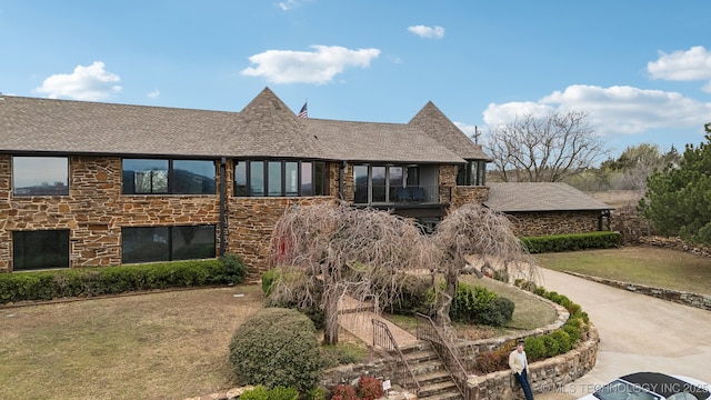 6642 E 60th Pl, Tulsa, OK 74145 - view of front of property with stone siding, a shingled roof, and a front lawn