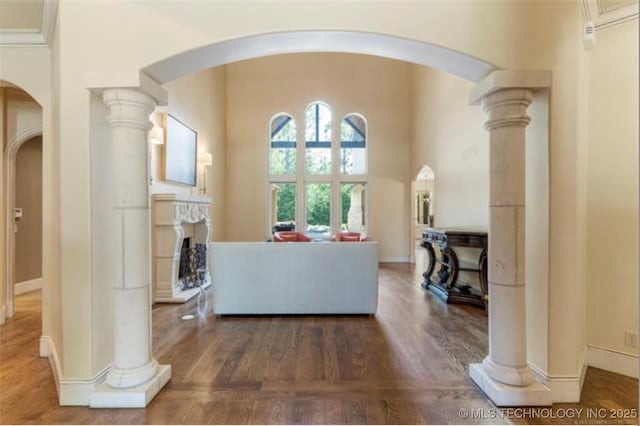 living room with dark hardwood / wood-style floors and ornate columns