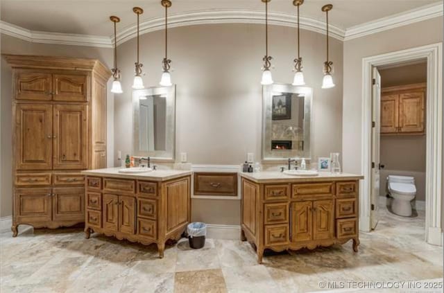 bathroom featuring ornamental molding, vanity, and a fireplace