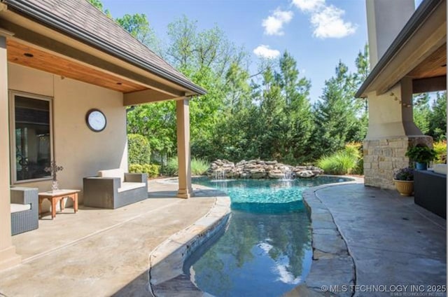 view of swimming pool with an outdoor living space and a patio