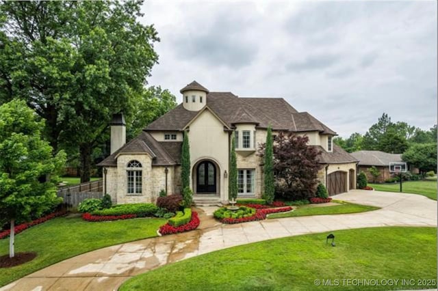 french country home featuring a front lawn