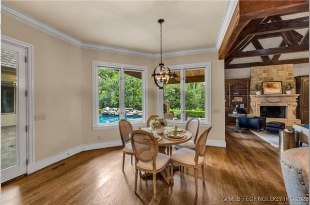 dining area with ornamental molding, a fireplace, and hardwood / wood-style floors