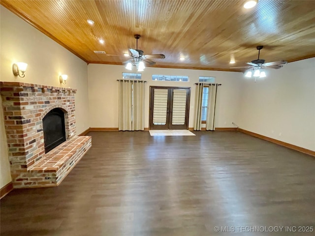 unfurnished living room featuring dark hardwood / wood-style flooring, a fireplace, wooden ceiling, and french doors