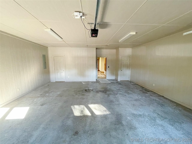 garage featuring a garage door opener and electric panel