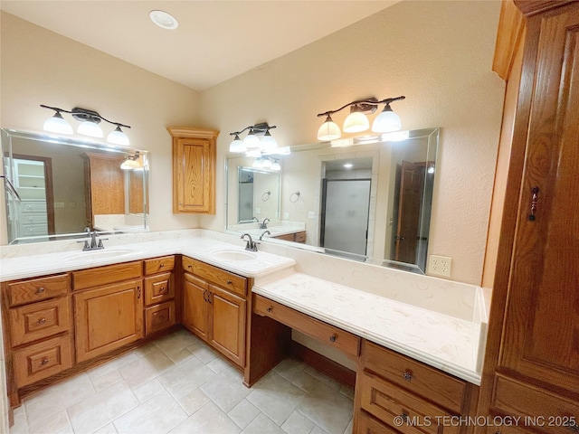 bathroom featuring an enclosed shower and vanity