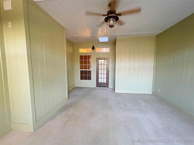 view of exterior entry featuring a patio and ceiling fan