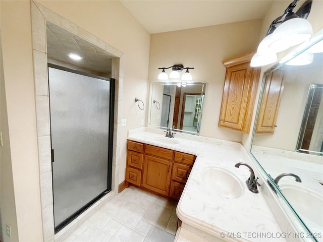 bathroom with tile patterned floors, vanity, and a shower with shower door