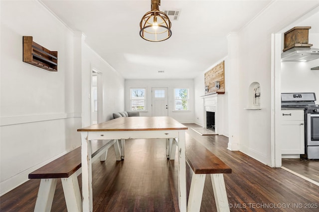 interior space featuring crown molding and dark hardwood / wood-style flooring