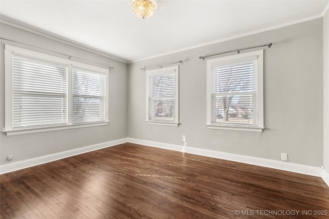 empty room with ornamental molding and dark hardwood / wood-style flooring