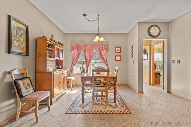 dining area with separate washer and dryer and light tile patterned floors