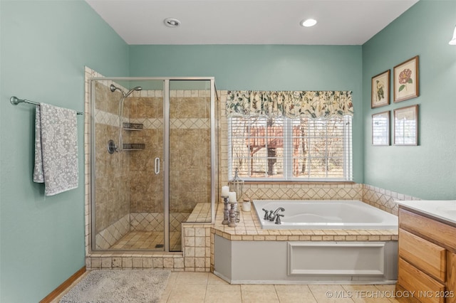 bathroom with tile patterned flooring, vanity, and plus walk in shower