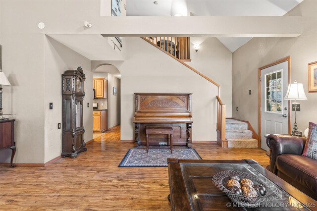 living room with beam ceiling and light hardwood / wood-style floors