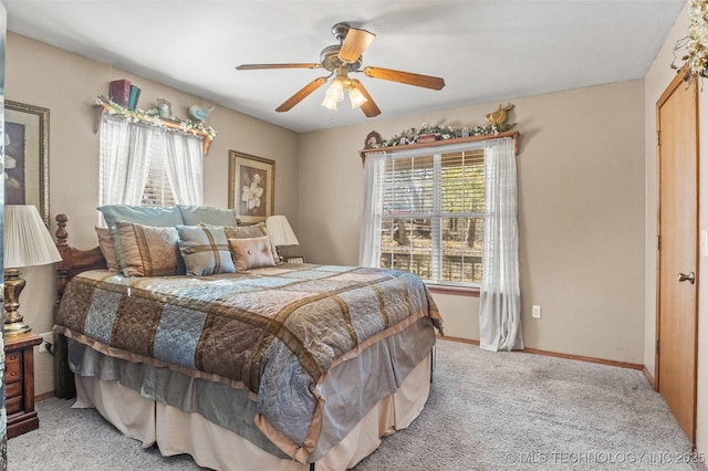 bedroom featuring a ceiling fan, light colored carpet, and baseboards