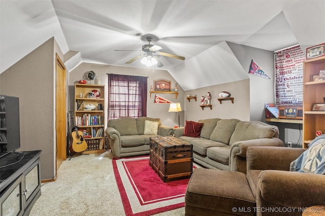 living area featuring vaulted ceiling, carpet floors, and a ceiling fan