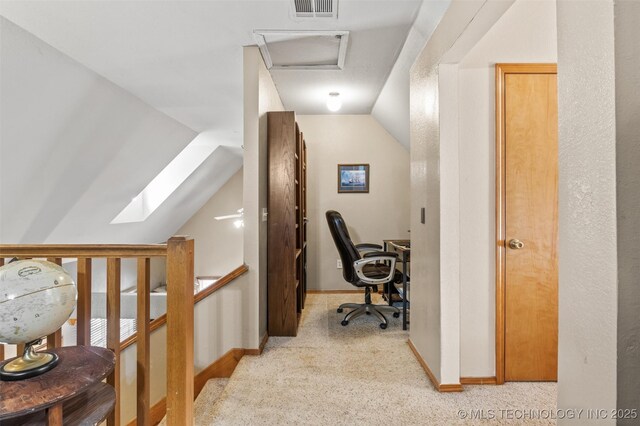 office space featuring lofted ceiling and light carpet