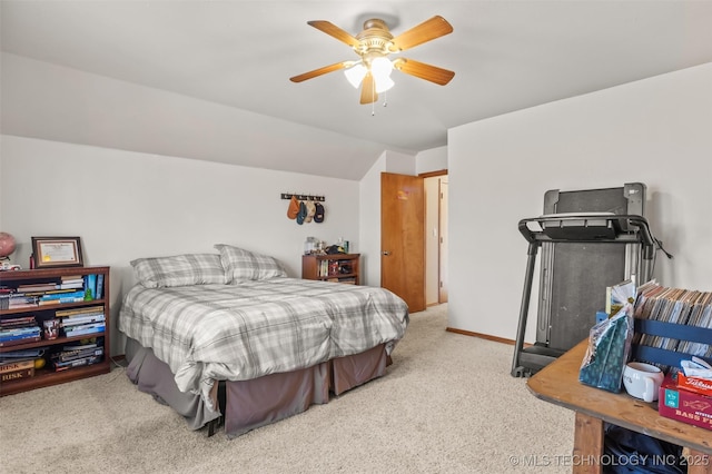 bedroom with vaulted ceiling, light colored carpet, and ceiling fan