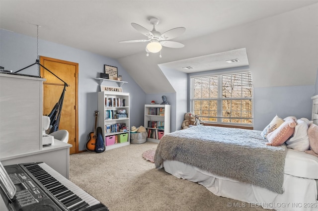 carpeted bedroom with ceiling fan and vaulted ceiling