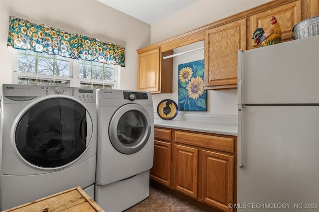 washroom with separate washer and dryer and cabinet space