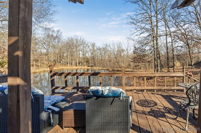 wooden terrace featuring a water view