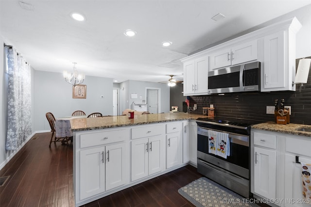 kitchen with white cabinetry, appliances with stainless steel finishes, dark hardwood / wood-style flooring, and kitchen peninsula