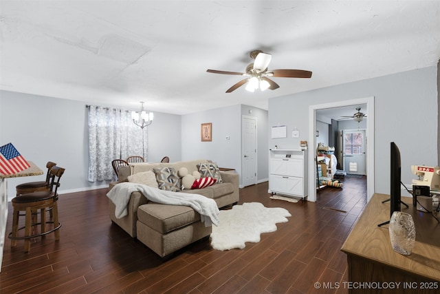 living room featuring ceiling fan with notable chandelier and dark wood-type flooring