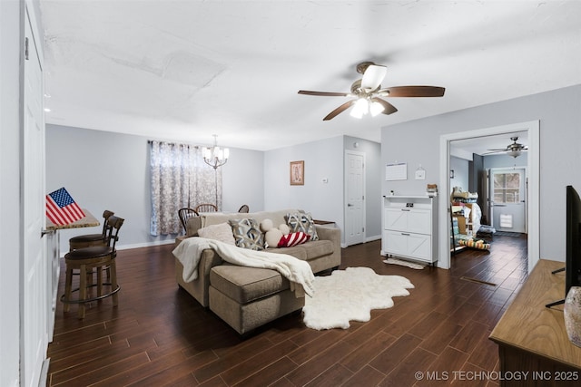 living room with dark wood-type flooring and ceiling fan with notable chandelier