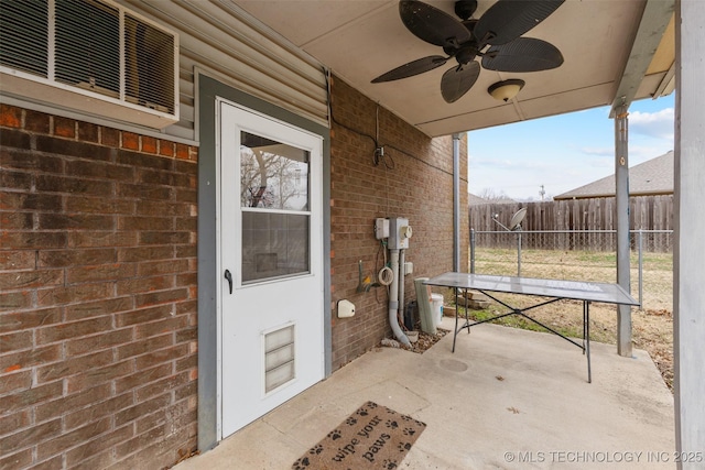 unfurnished sunroom with ceiling fan