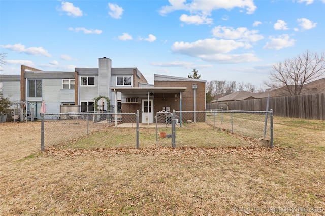 rear view of house with a yard