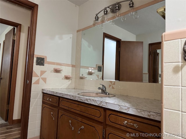 bathroom with tile walls and vanity