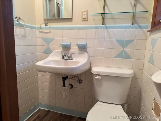 bathroom featuring tile walls, sink, wood-type flooring, and toilet