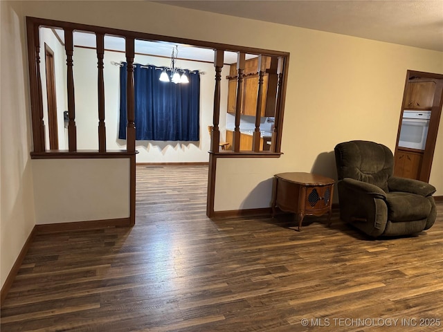 interior space with a notable chandelier and dark wood-type flooring