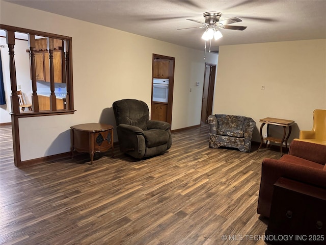 living room featuring dark hardwood / wood-style floors and ceiling fan