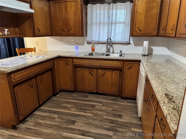 kitchen featuring tasteful backsplash, sink, dark wood-type flooring, and white appliances