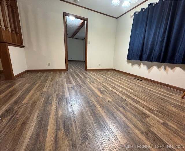 unfurnished room featuring ornamental molding and dark hardwood / wood-style floors