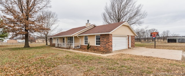 view of side of property featuring a garage, a porch, and a lawn