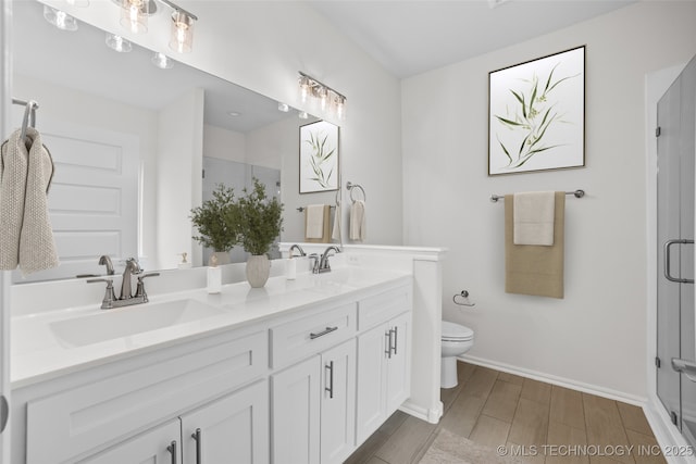 bathroom featuring walk in shower, vanity, and toilet