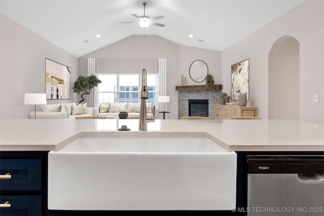 kitchen featuring sink, vaulted ceiling, stainless steel dishwasher, and ceiling fan