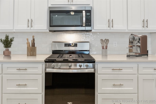 kitchen featuring white cabinetry, appliances with stainless steel finishes, and decorative backsplash