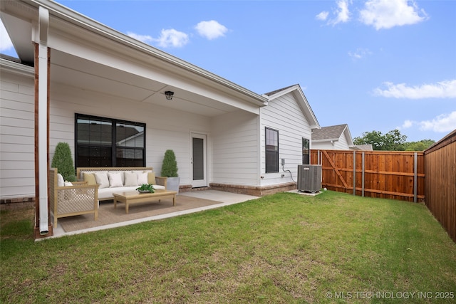 back of property with cooling unit, an outdoor living space, a yard, and a patio