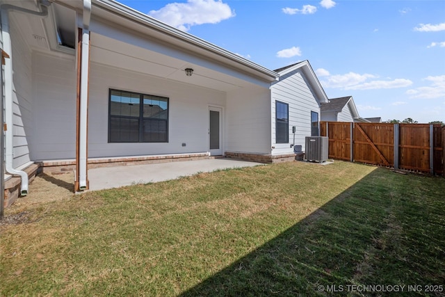 back of property featuring central air condition unit, a patio, and a lawn