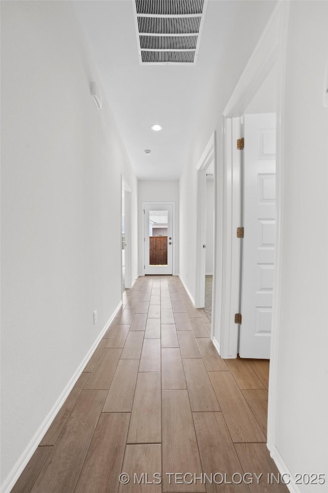 corridor featuring light hardwood / wood-style flooring